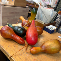 Decorative gourds on a wooden surface with a blurred indoor background
