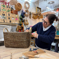 guest repairing handles on cane basket