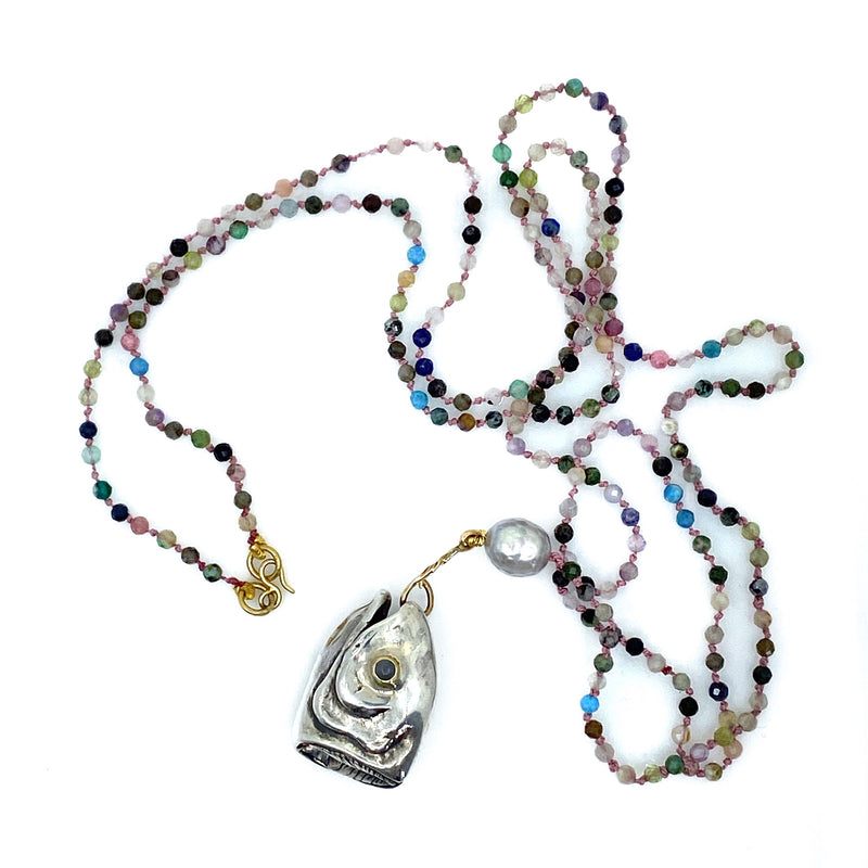 A sterling silver fish-shaped pendant with a large irregular pearl, 18ct yellow gold, cabochon moonstone and faceted natural tourmaline beads, with a length of 104cm.